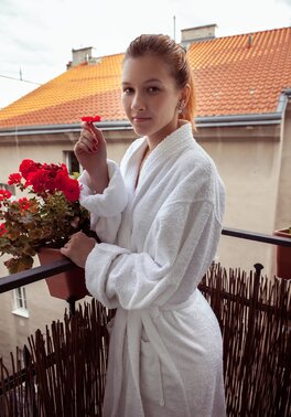 Long-legged young redhead breathes fresh air and enters home to pose naked