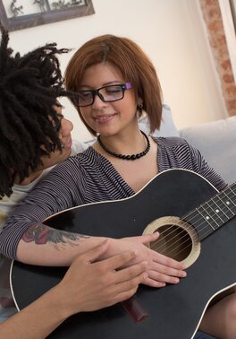 Ebony guy plays on guitar making nerdy redhead Rebecca Rainbow in mood for sex