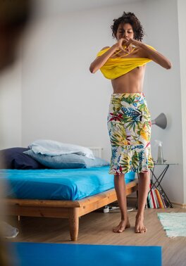 Tall Adriana E covers her skinny body with a multicolor skirt and top