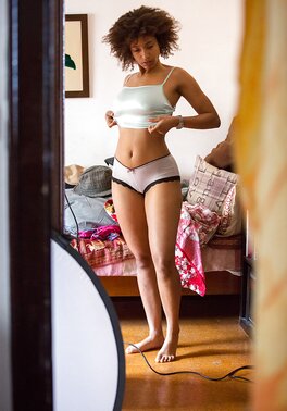 Black teen unconsciously exposes her small titties and hairy twat before dressing