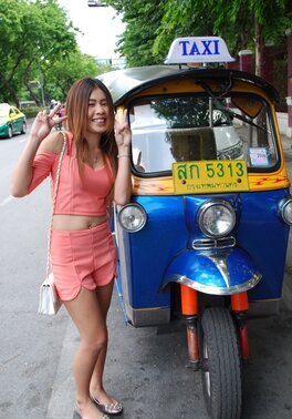 Joyful Thai minx poses near white fellow and his impressive auto rickshaw
