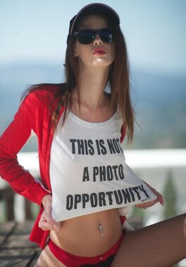 Tiny babe with sunglasses discards swimsuit and teases with her tits and pussy