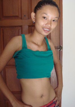 Skinny Asian girl is going to show nude body in a doorway