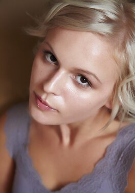 Her oval face is framed by thin eyebrows and perky ears