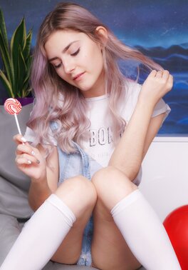 Eva Elfie enjoys stripping to her socks and toying her bald pussy