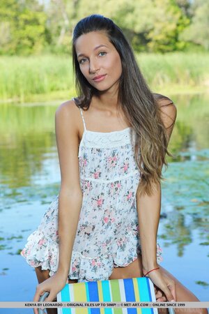 Slender chick doesn't hesitate to pose nude in fresh air near river
