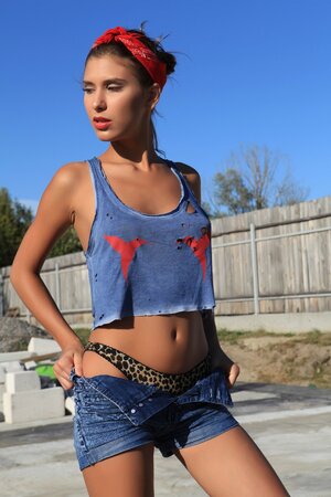 Willowy model disrobes flawless tanned body and poses in the sunrays