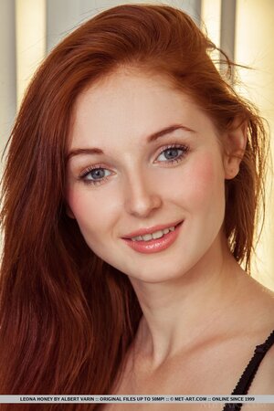 Red-haired sexpot Leona Honey not shy to take clothes off and show her assets
