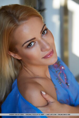 Lassie in a blue robe confidently opens it and flaunts her tiny charms