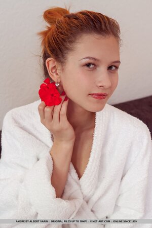 Long-legged young redhead breathes fresh air and enters home to pose naked