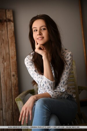 Beautiful brown-eyed teen takes off shirt and jeans at the photo session