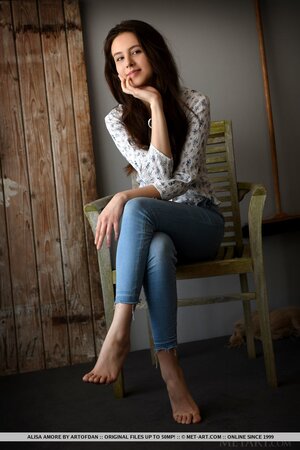 Beautiful brown-eyed teen takes off shirt and jeans at the photo session
