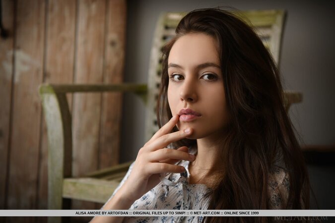 Beautiful brown-eyed teen takes off shirt and jeans at the photo session