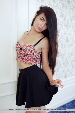 Tiny raven-haired angel Debora A displays fragile body in her cozy bedroom