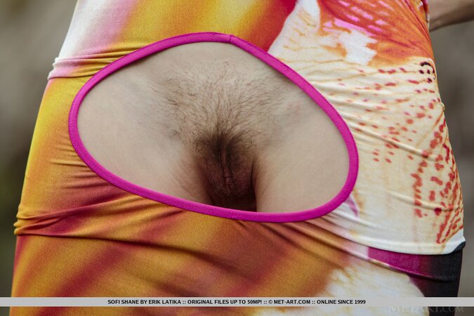 Chick in a colorful summer dress walks in nature and strips being alone