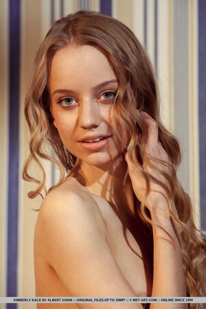 Young woman with small titties poses putting naked vagina in the camera