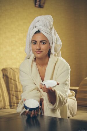 Whore with a towel on head and in white robe gives sexual pleasure to pussy
