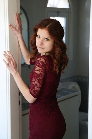 Red-haired chick rubs her unshaved pussy and spreads it with two fingers
