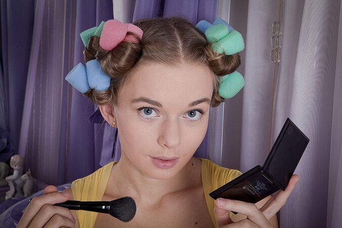 Teen chick undresses and stimulates clit of bushy pussy while pin-curling hair