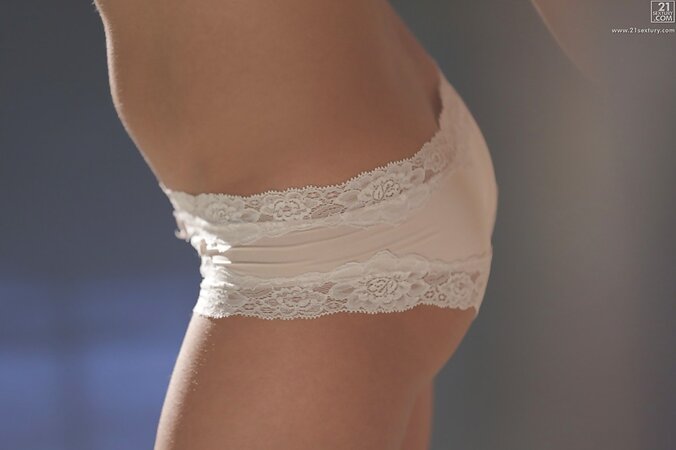 Light shines on wonderful girl who tries to reach sweet orgasm using fingers