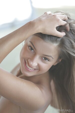 Pretty student stretches on the mat and gets naked appreciating body in mirror