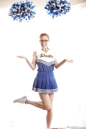 Funny red-haired high-school cheerleader Penny Pax strips while dancing