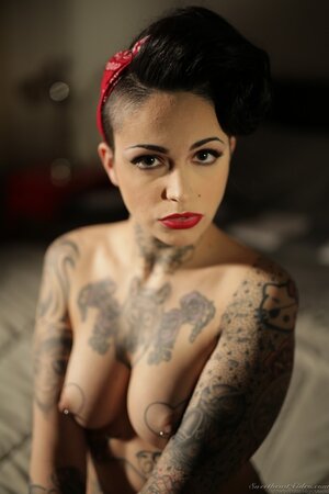 Inked brunette has enough talent to pose naked in image of pinup model