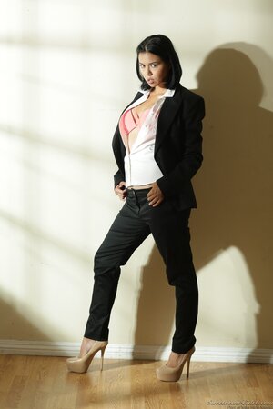 Alone Asian woman loves to take off suit and pose completely nude near wall