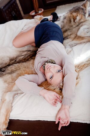 Excitement fills astonishing blonde girl and she plays with pussy on the bed
