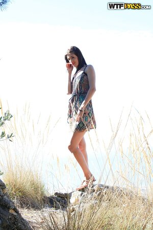 Naked photo session of good-looking model takes part under the open sky