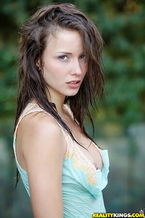 Enticing cutie with perky tits seductively poses outdoors after rain