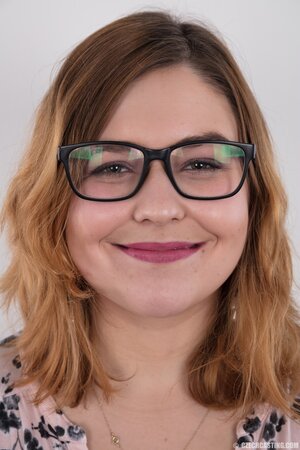 Fat whore with glasses rocks out in the porn studio trying striptease skills out