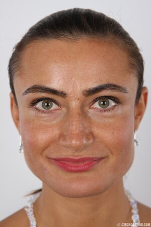 Female with green eyes wears white pants and bra but black panties at photoshoot