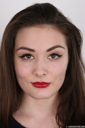 Brunette chick with red lipstick on and mesmerizing look feels free to act dirty