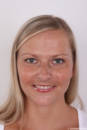 Female with freckled face ready to get naked and expose her hospitable opening