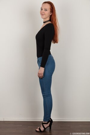 Pale chick with red hair unveils small breasts but doesn't take black panties off