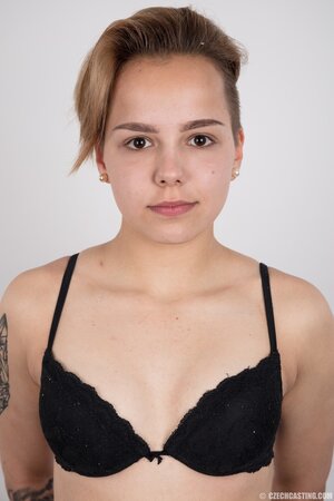 Young woman with small nice boobies and boyish figure doesn't shy to get naked