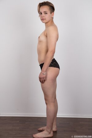 Young woman with small nice boobies and boyish figure doesn't shy to get naked
