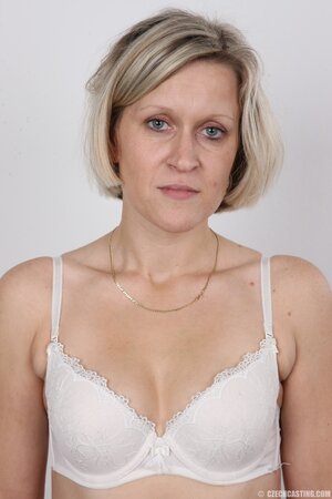 Blonde mature woman in jeans and white lingerie doesn't protect her privacy