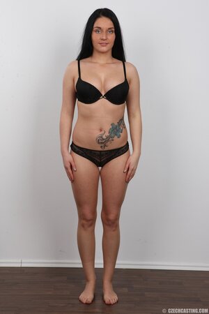 Brunette chick with pierced upper lip and tattooed belly remains naked