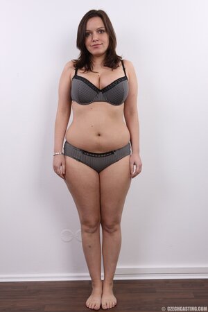 Young woman has two different-sized tits hidden under bra to show off