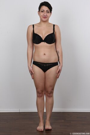 Slutty female in black bury shyness and comes to a porn studio to pose in the nude