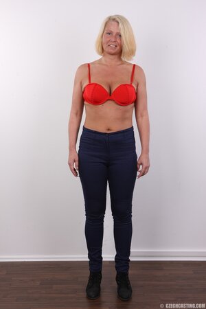 Photographer takes pictures of cheerful mature woman with blonde hair