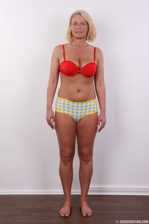 Photographer takes pictures of cheerful mature woman with blonde hair
