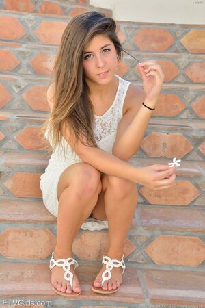 Girl in white dress with cute smile can't believe her luck to masturbate outdoors
