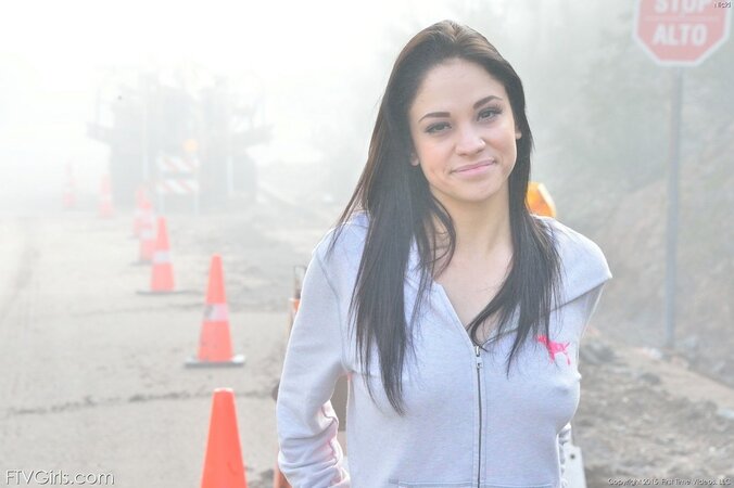 Young woman with small tits and pierced nipples loves stripping in the fog
