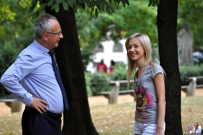 Beauty follows old lovelace to pose with small gun and sit on his face