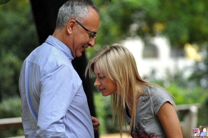 Beauty follows old lovelace to pose with small gun and sit on his face