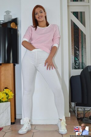 Classy redhead demonstrates perky tits and pussy in provocative ways