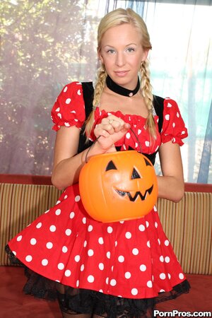 Naughty girl takes off her Halloween dress and poses in sexy stockings
